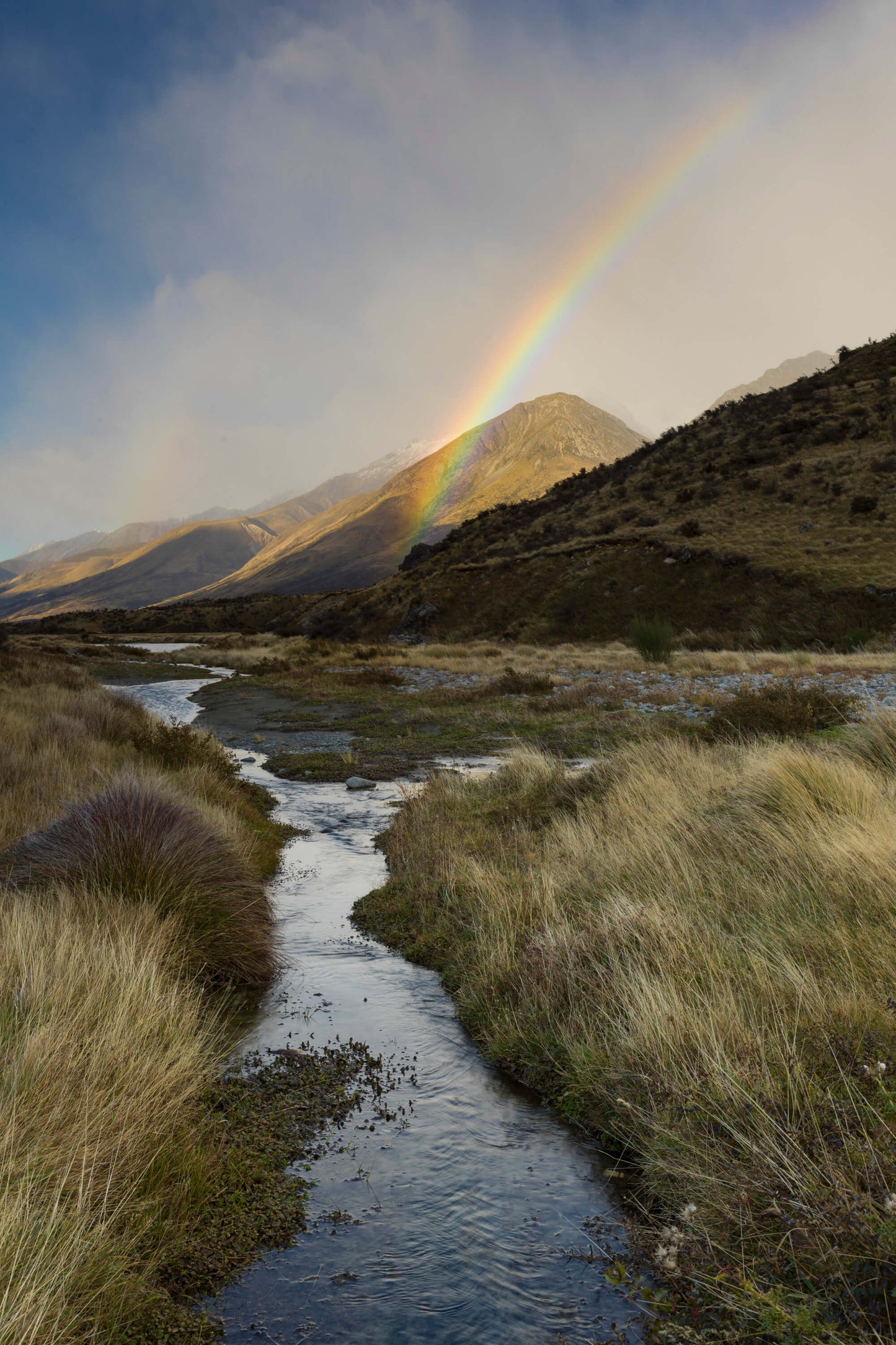 End of rainbow after a rainstorm near Mt. Cook on New Zealand's South Island