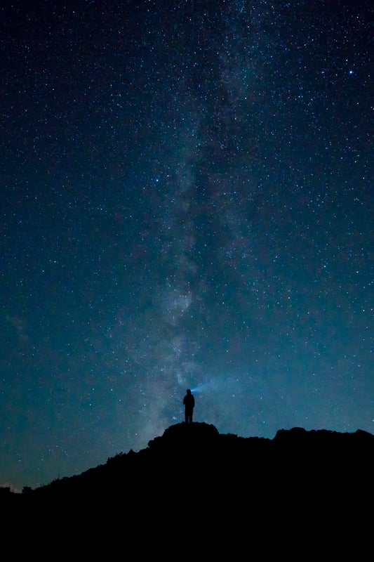 person standing alone under the stars on a mountainside in Colorado
