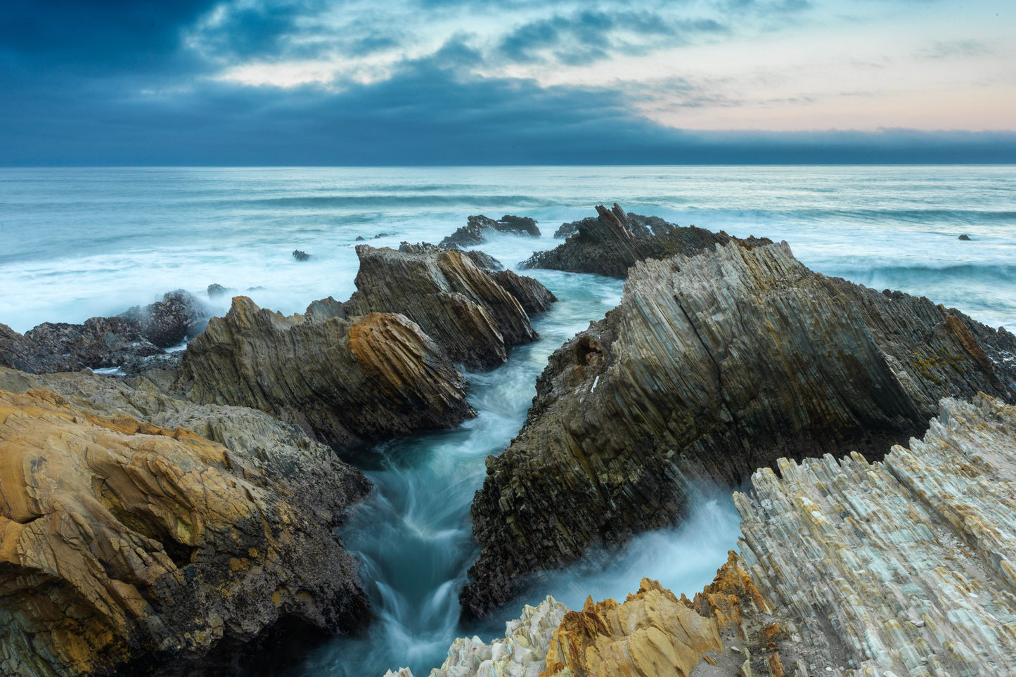 jagged shoreline of the California coast looking westward into the Pacific Ocean over the horizon